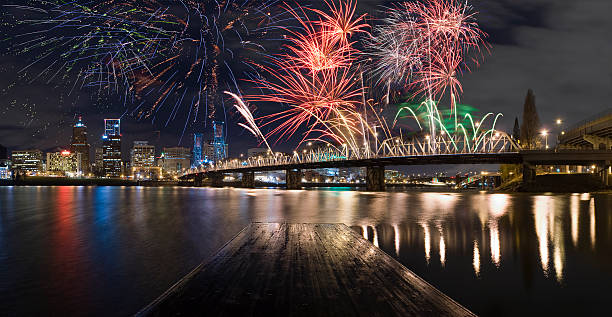 Fireworks over downtown Portland with reflections on the water.  Celebrate New Years in Portland