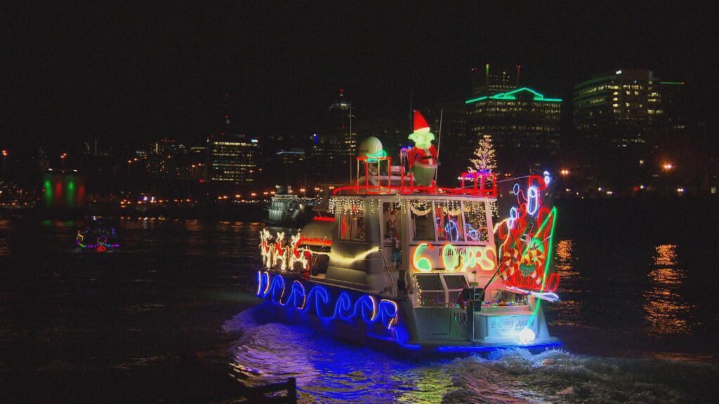 Santa on decorated boat in Christmas Ships Parade Portland 2025