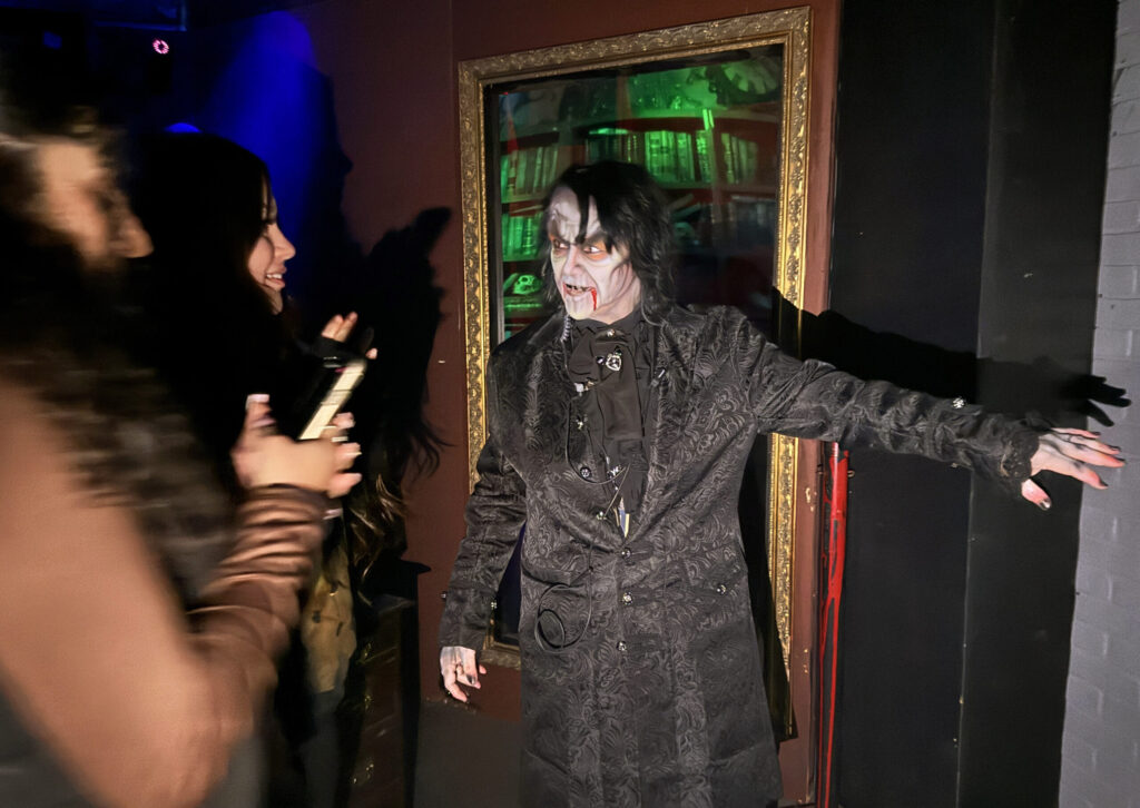 Actors scaring visitors inside the 13th Door Haunted House Portland 2025
