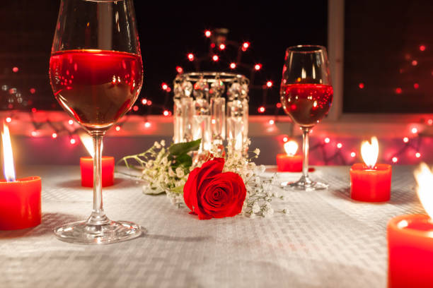 Candlelit restaurant table with wine and flowers